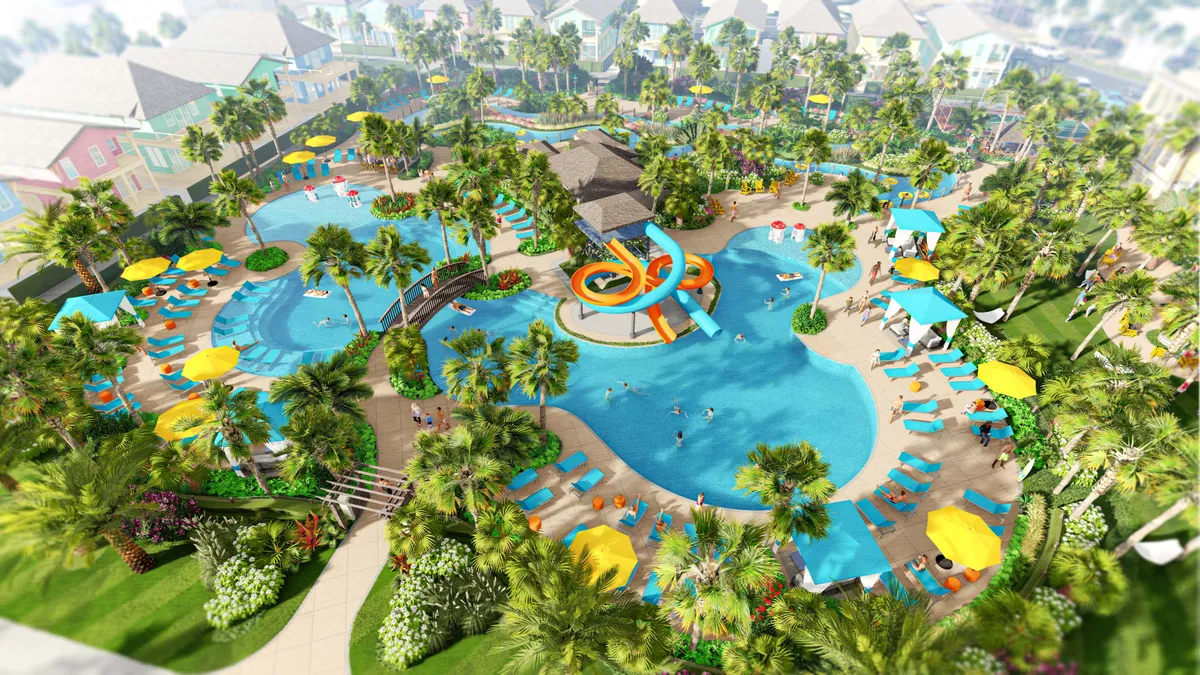 A lively resort pool complex featuring winding water slides, a meandering lazy river, colorful umbrellas and lounge chairs, and vibrant tropical landscaping. Families and children are visible enjoying the water features, and the overall environment is playful and vacation-like.
